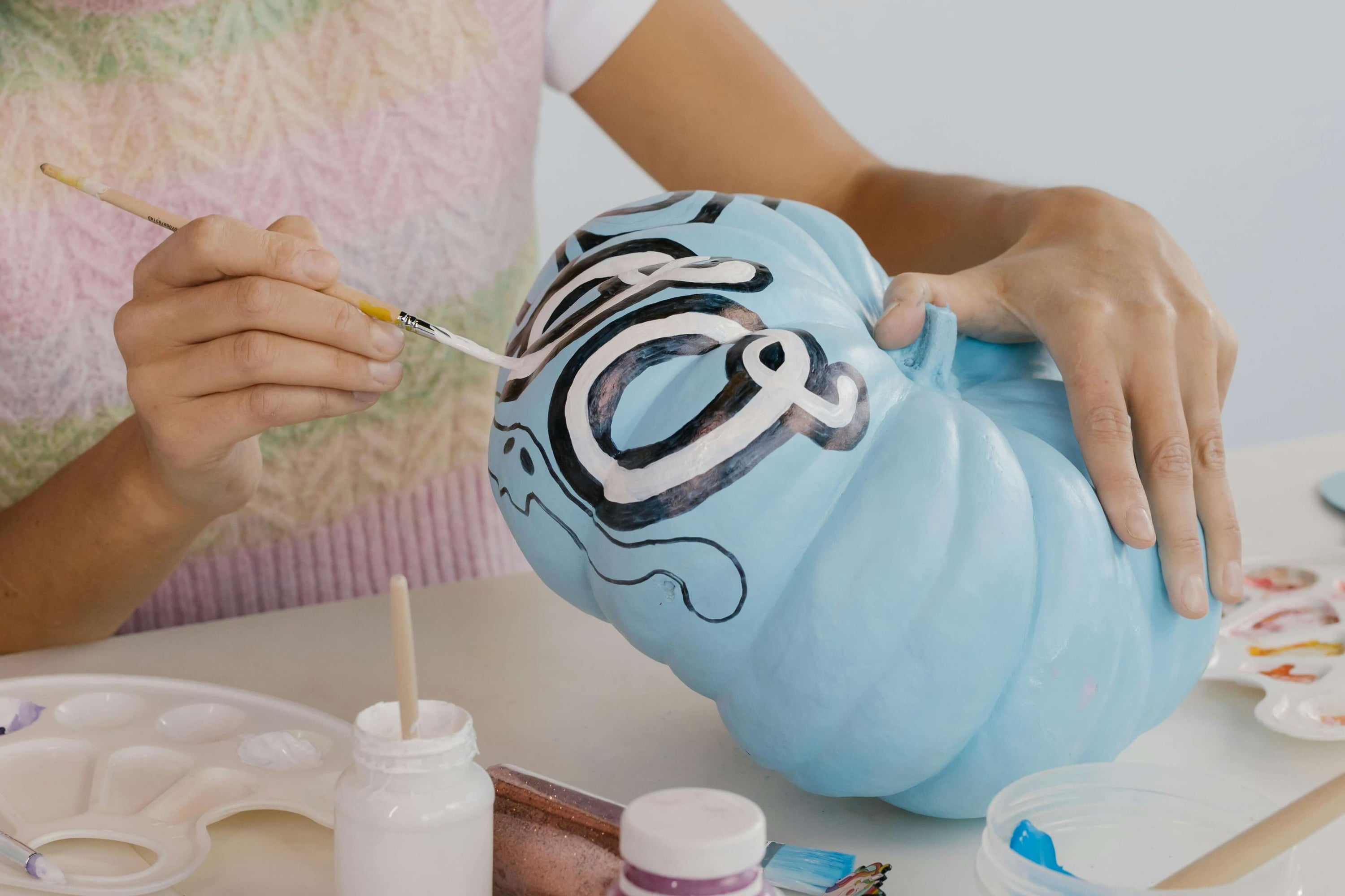 Teal pumpkin on a porch, signaling allergy-friendly treats for kids during Halloween